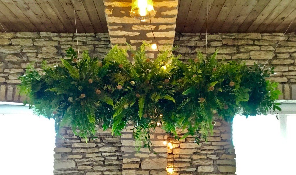 Hanging from the ceiling, a chandelier made of all greens