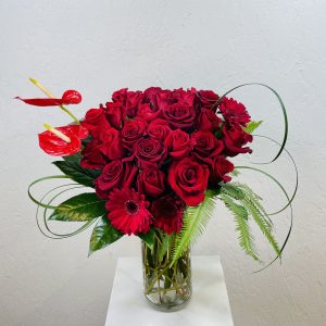 24 Red roses, red anthuriums, and red gerbera daisies designed by La Paloma Blanca Floral Designs in Scottsdale, AZ