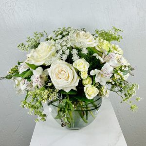 clear bubble bowl with white roses, white spray roses, alstromeria, and queen anne's lace designed by La Paloma Blanca Floral Designs in Scottsdale, AZ