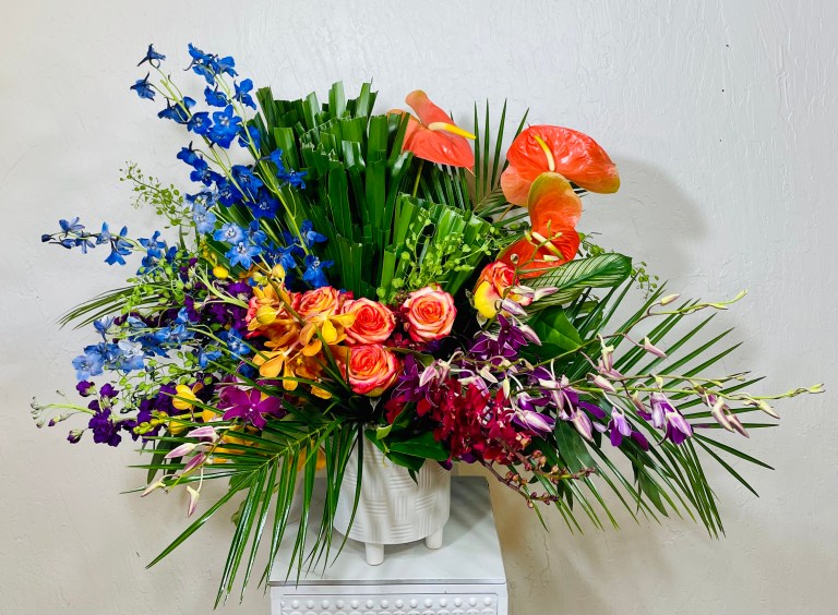 White Footed Pot with Blue Delphinium, purple dendrobium orchids, red James Story Orchids, purple orchids and peach anthuriums @ la paloma blanca floral designs scottsdale, az